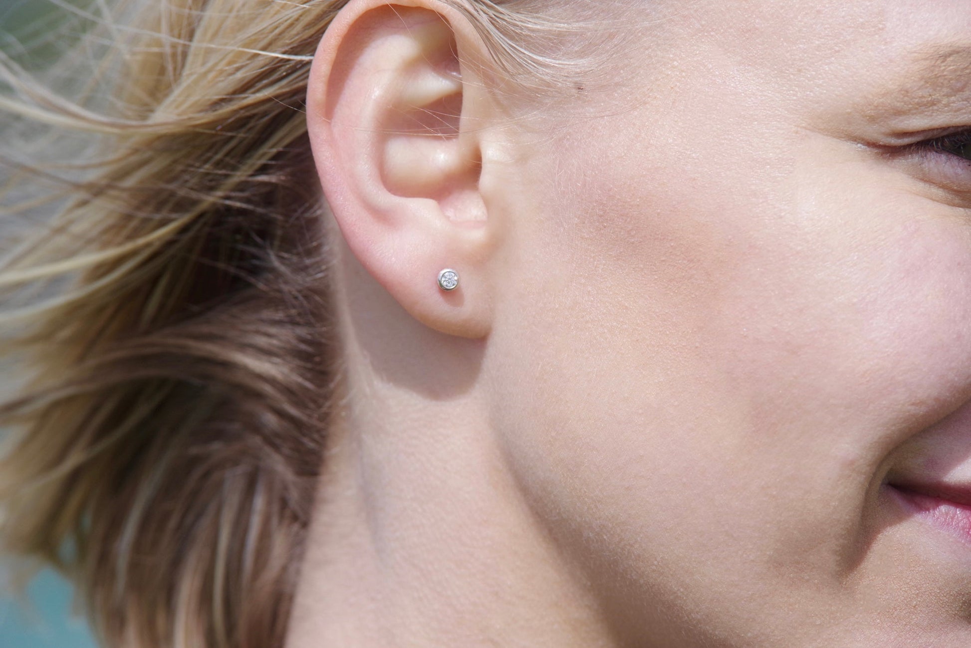 Moissanite Solitaire Silver Stud Earrings – DEI Collection by Booblinka Jewellery on a model