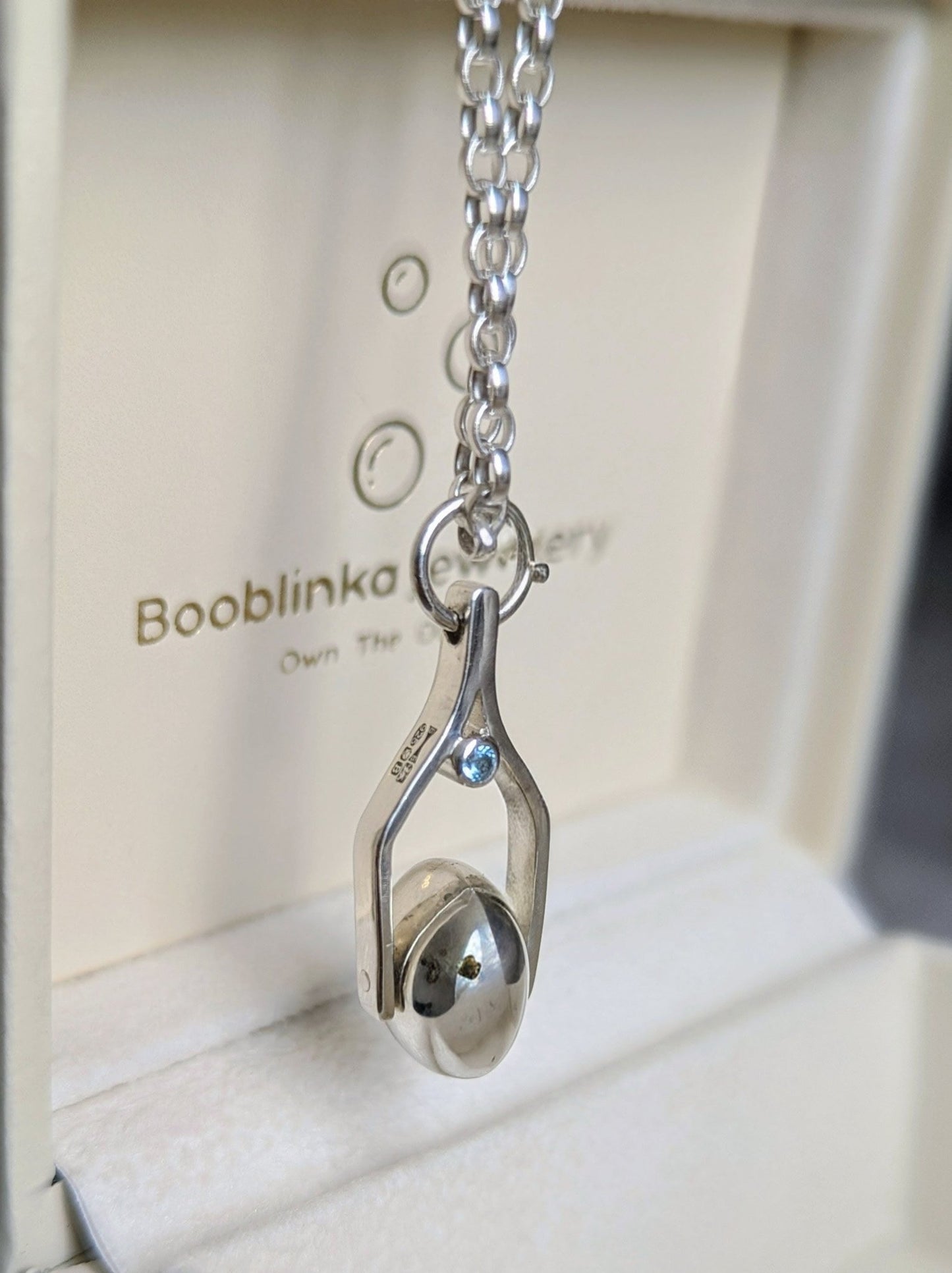 Sterling silver spinning necklace with Swiss blue topaz handmade in Cornwall made by Booblinka Jewellery
