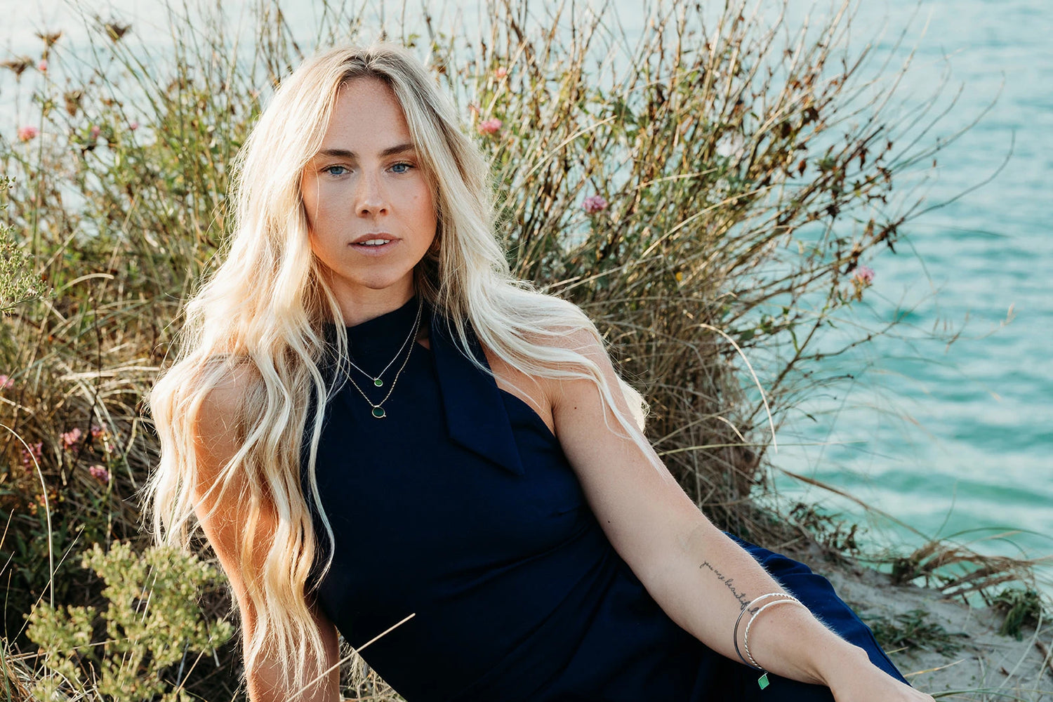 Model in sea background wearing jewellery made by Booblinka Jewellery