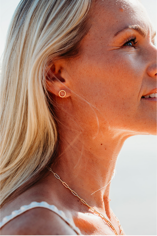 Handmade 9ct gold circle stud earrings worn on the ear, simple everyday solid gold earrings by Booblinka Jewellery