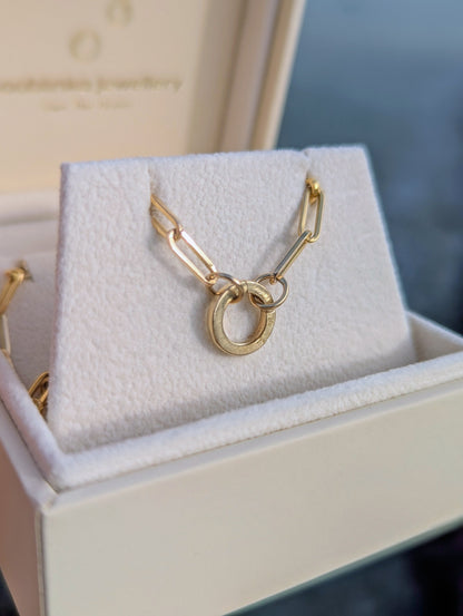 Gold paperclip necklace with a unique design hinged round connector in a jewellery box made by Booblinka Jewellery.
