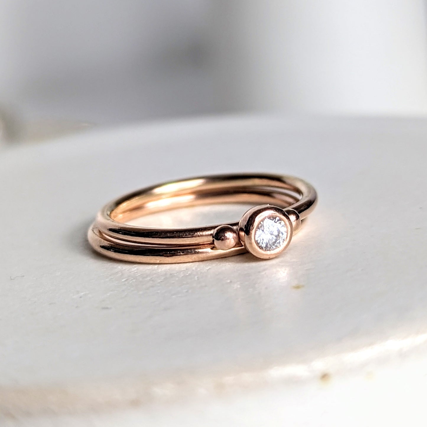 Dainty rose gold stacking engagement rings with sparkly moissanite DEI collection by Booblinka Jewellery 