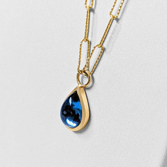 Detail of London Blue Topaz Teardrop Necklace in Solid 9 Carat Gold with delicate shimmering paperclip chain from  Ocean Collection by Booblinka Jewellery