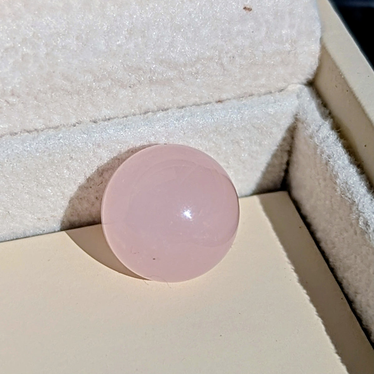 Close-up of the smooth pale pink Rose Quartz sphere available to choose for the silver ORB necklace