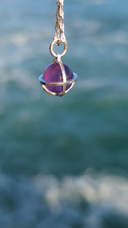 Amethyst sphere silver necklace above the ocean video
