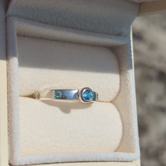 Video of Silver ring with Swiss blue topaz and blue cubic zirconia gemstones in a jewellery box made by Booblinka Jewellery