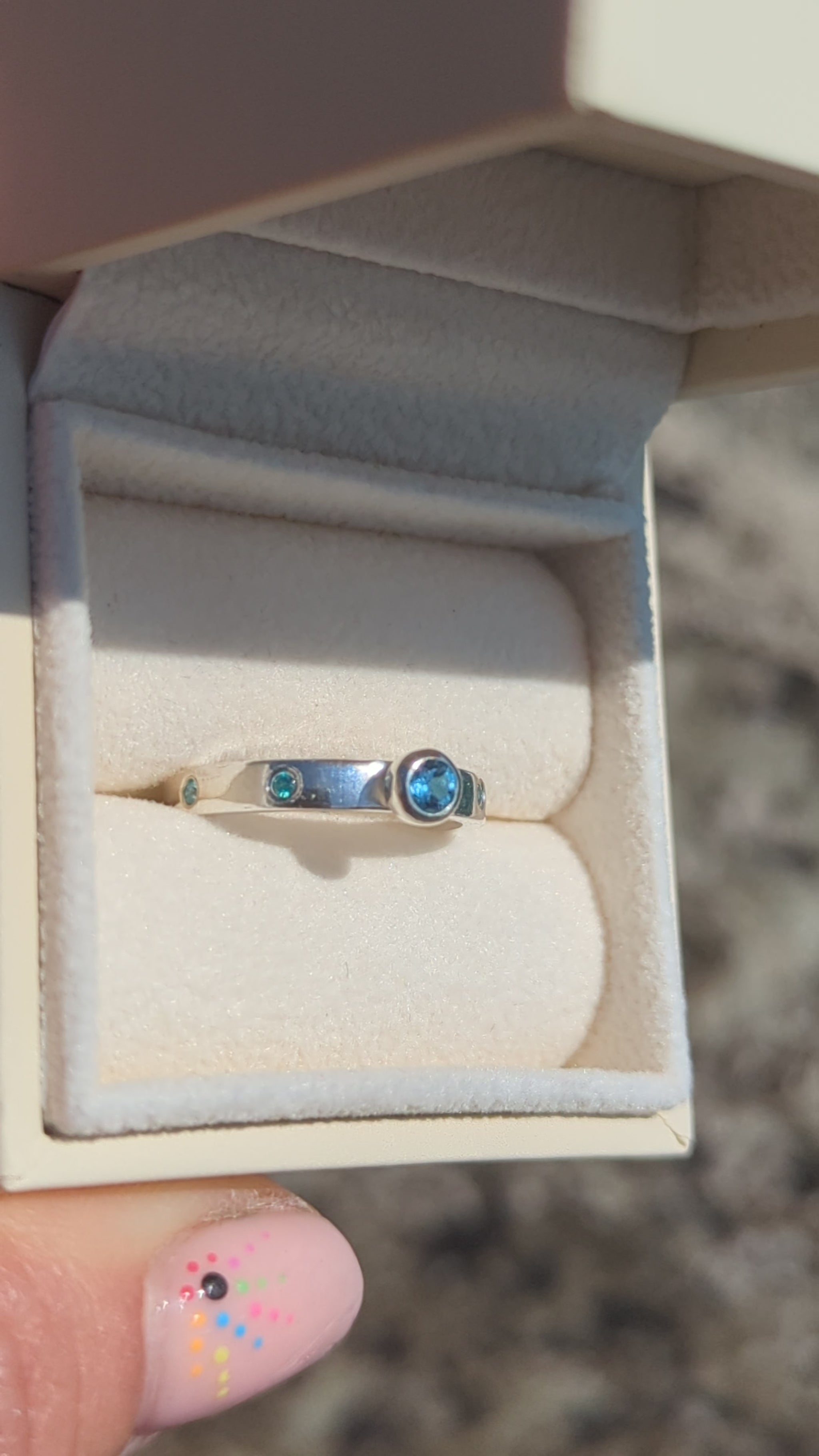 Video of Silver ring with Swiss blue topaz and blue cubic zirconia gemstones in a jewellery box made by Booblinka Jewellery