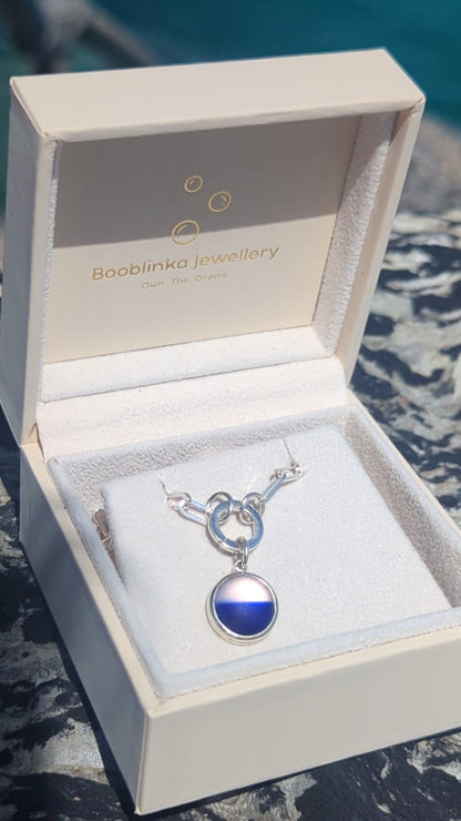 Video showing how to open the sterling silver hinged charm holder and attach the blue and white sea glass pendant to the chain.