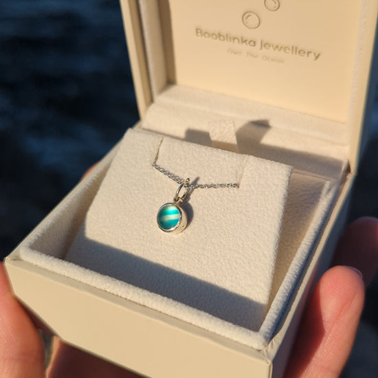 One-of-a-kind teal sea glass necklace in solid 9ct white gold presented in a Booblinka Jewellery gift box.