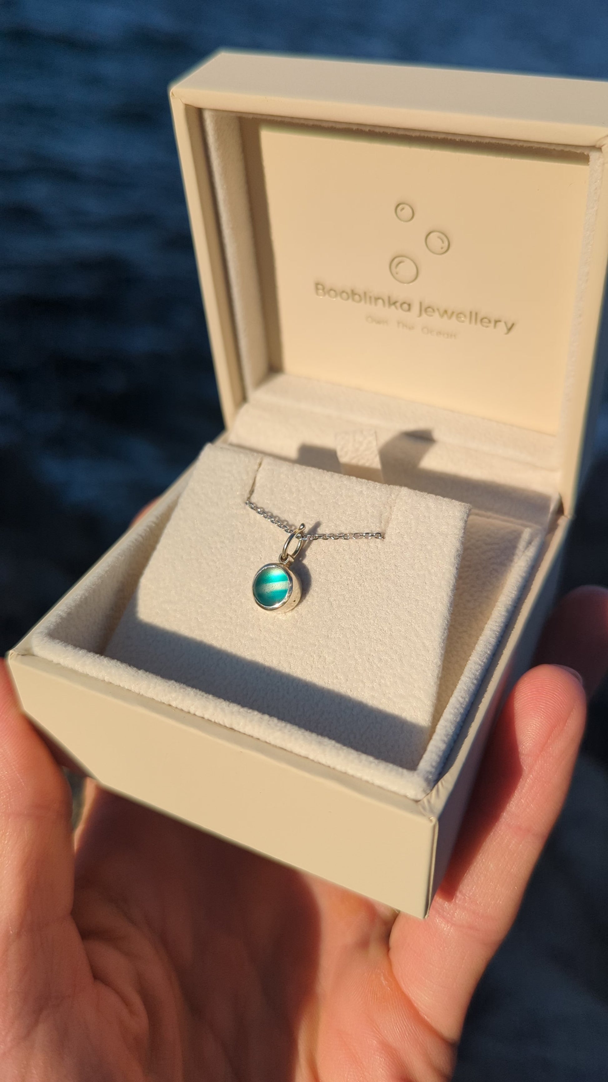 One-of-a-kind teal sea glass necklace in solid 9ct white gold presented in a Booblinka Jewellery gift box.