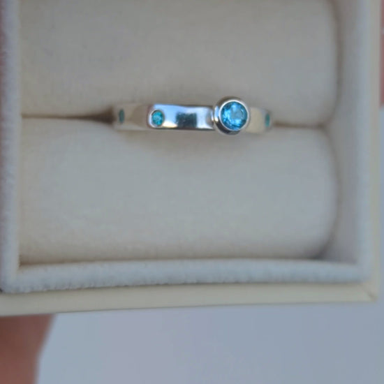 Video of a Silver ring with Swiss blue topaz and blue cubic zirconia gemstones in a jewellery box  made by Booblinka Jewellery