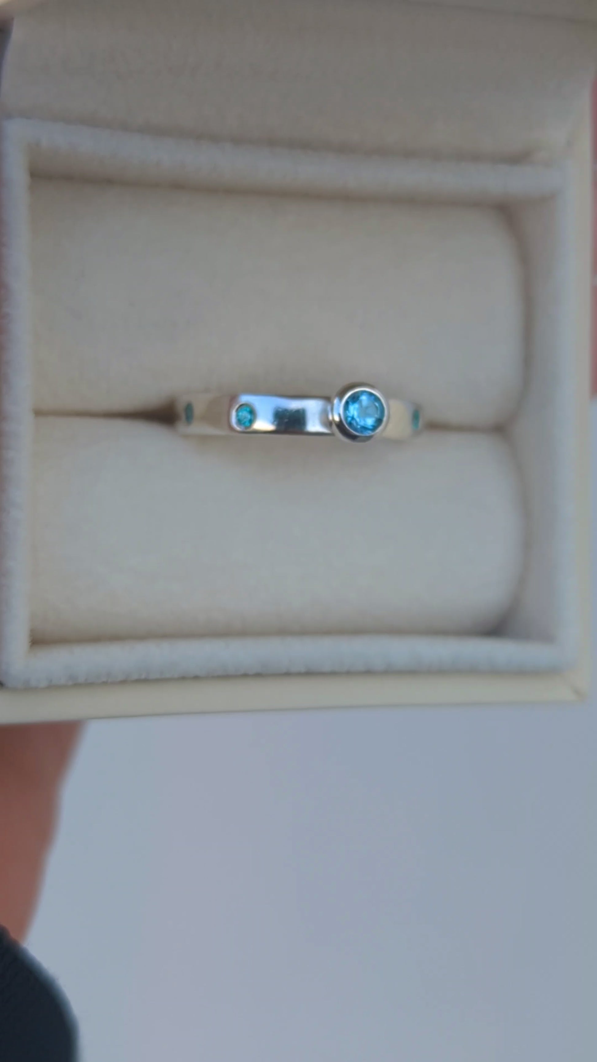 Video of a Silver ring with Swiss blue topaz and blue cubic zirconia gemstones in a jewellery box  made by Booblinka Jewellery