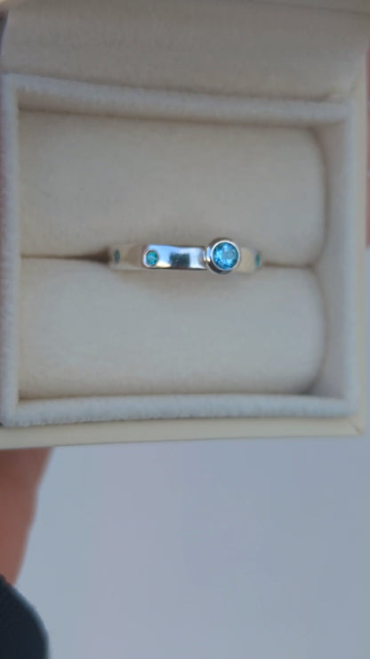 Video of a Silver ring with Swiss blue topaz and blue cubic zirconia gemstones in a jewellery box  made by Booblinka Jewellery