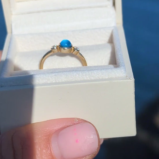 Gold engagement ring with a blue sea glass and two ocean diamonds in an ivory jewellery box made by Booblinka Jewellery