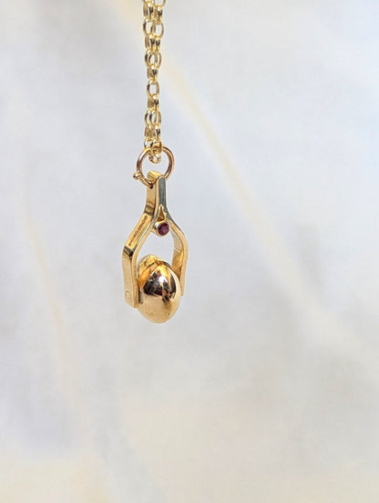 Gold Spinning Moon Necklace with pink tourmalines made by Booblinka Jewellery with a detail of hallmark