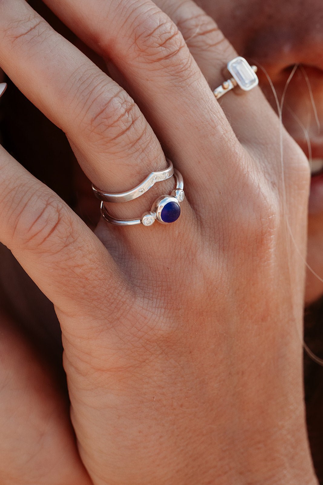 Sterling Silver Engagement Ring with Cobalt Sea Glass & Moissanites  on a finger - Handmade in Cornwall by Booblinka Jewellery