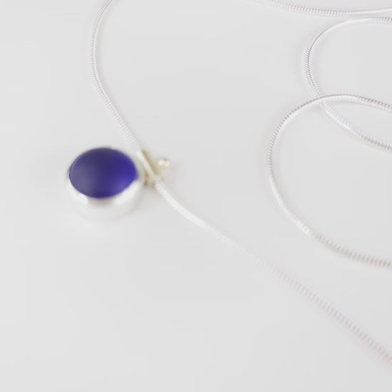video of spinning deep blue cobalt sea glass necklace with silver snake chain