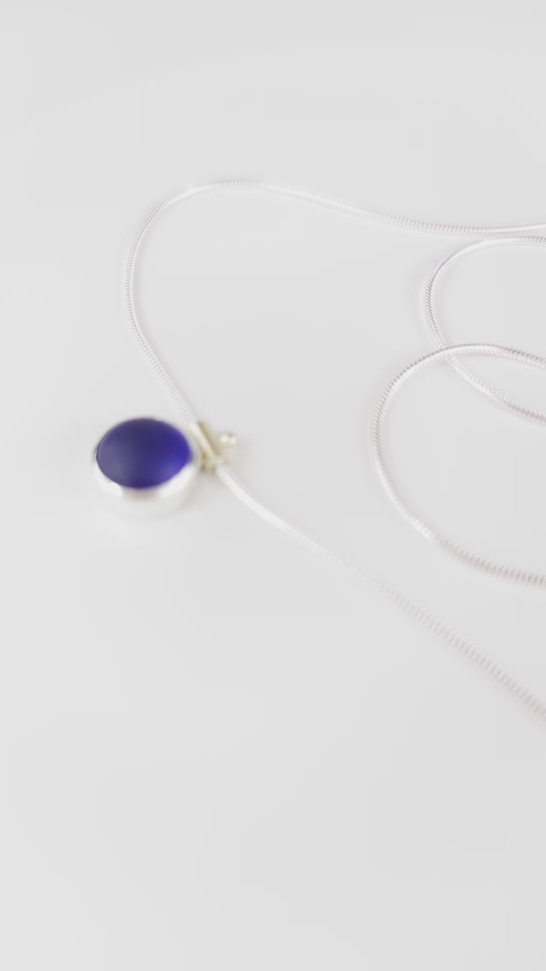 video of spinning deep blue cobalt sea glass necklace with silver snake chain