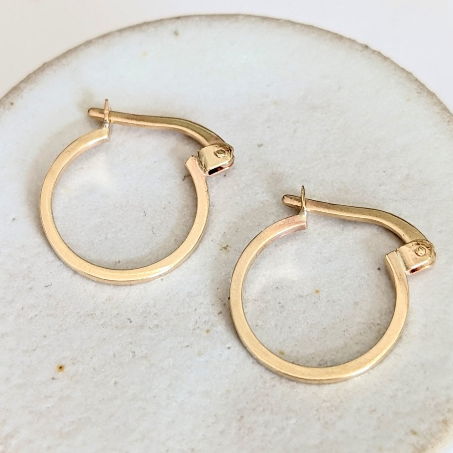 9ct gold hoop earrings  on off-white ceramics background handmade by Booblinka Jewellery