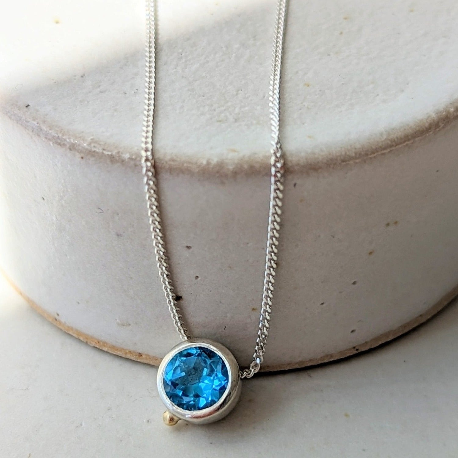 Handcrafted Daria Swiss Blue Topaz Necklace with 16-inch Sterling Silver Chain from Ocean Collection in Cornwall. Capturing the essence of Cornwall's seas. Handcrafted with a 16-inch Sterling Silver Chain and a beautiful 5mm Topaz.