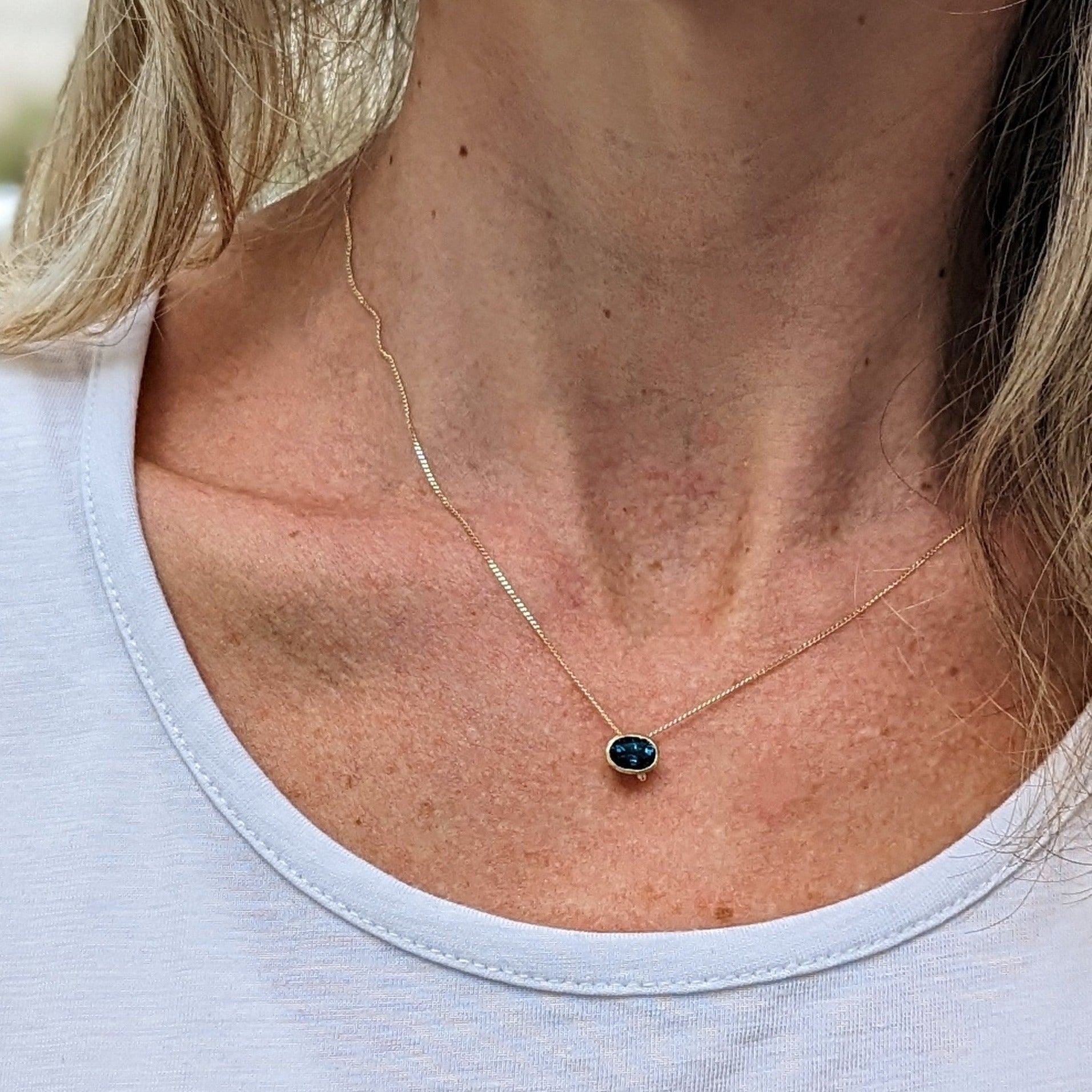Oval London Blue Topaz Necklace in 9 Carat Gold from Ocean Collection made by Booblinka Jewellery worn on a model
