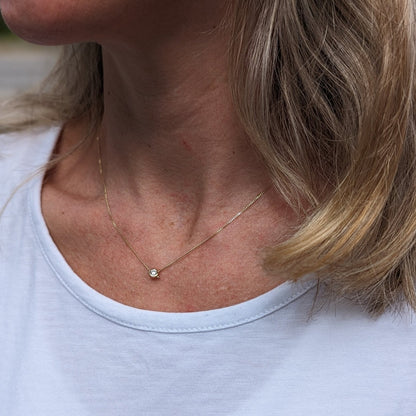 Gold Floating Moissanite Necklace – DEI Collection by Booblinka Jewellery on a model