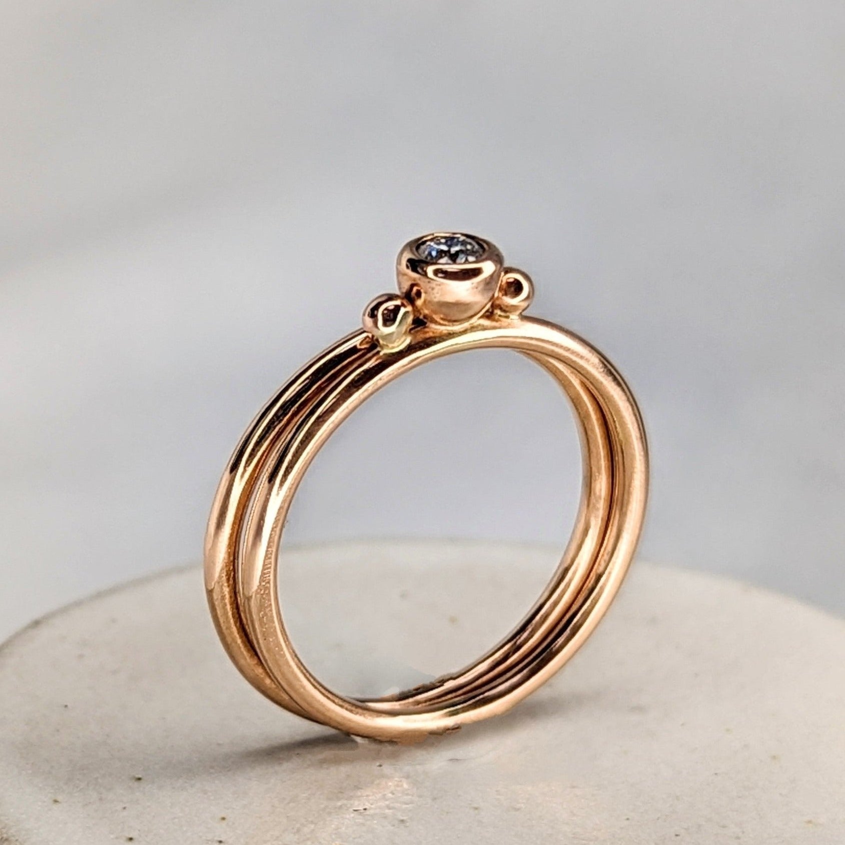 Dainty rose gold stacking engagement rings with sparkly moissanite DEI collection by Booblinka Jewellery