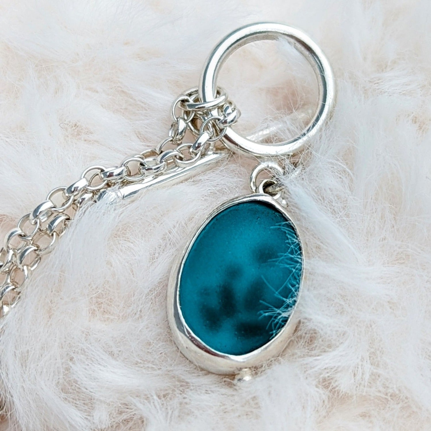 Reversible Deep Teal Silver Sea Glass Necklace - Close-up of a handmade silver necklace with a teal sea glass pendant, featuring a toggle clasp. The pendant design highlights ocean-inspired artistry and sustainable jewellery craftsmanship made by Booblinka Jewellery.