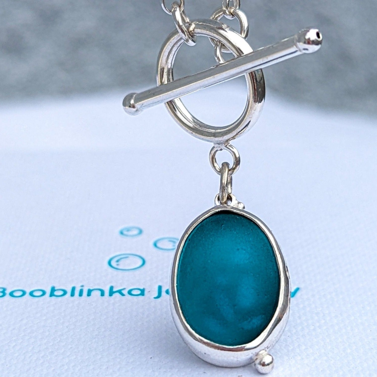 Teal oval sea glass silver necklace with nature design and satin finish with toggle clasp by Booblinka Jewellery