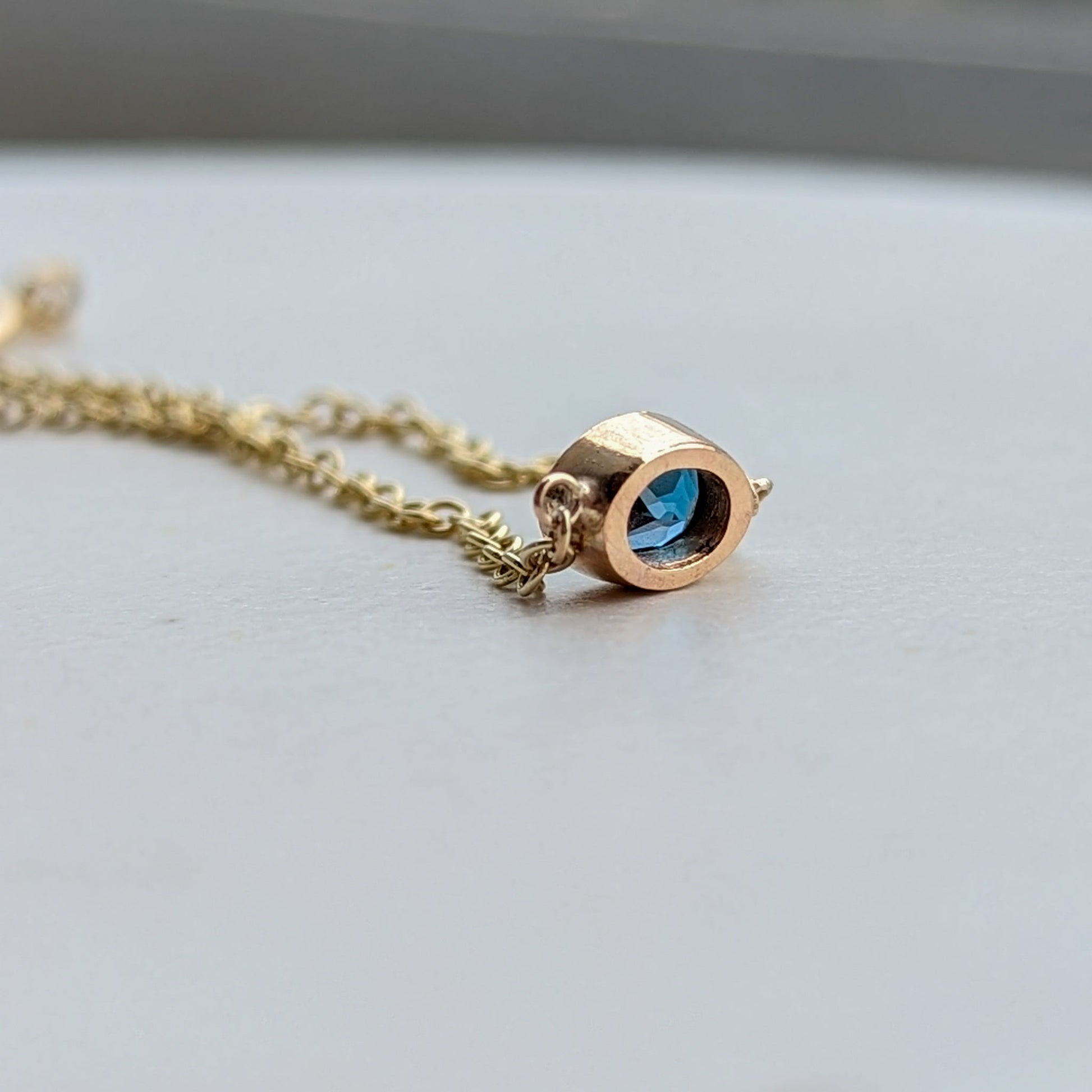 Gold bracelet with oval London blue topaz