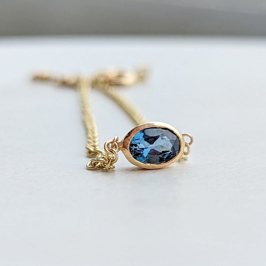 Gold bracelet with oval London blue topaz by Booblinka Jewellery